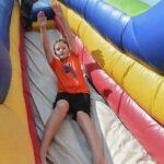 boy goes down slide